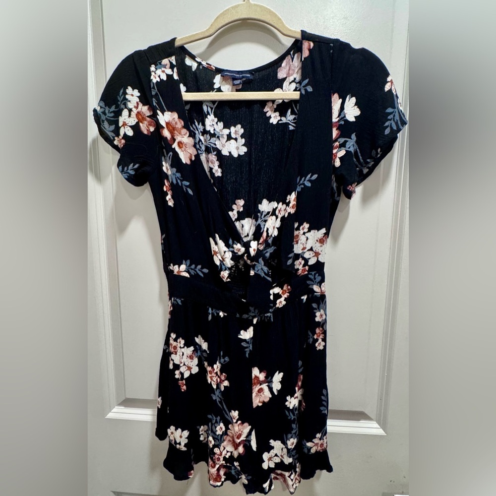 Black Romper with pink floral pattern with key hole tie detail in the front